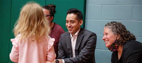 Superintendent greeting student